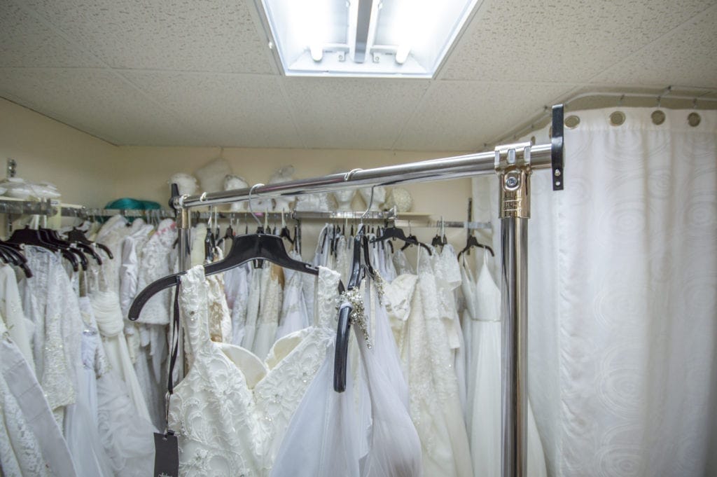 Picture of store owner who built a heavy-duty clothing rack