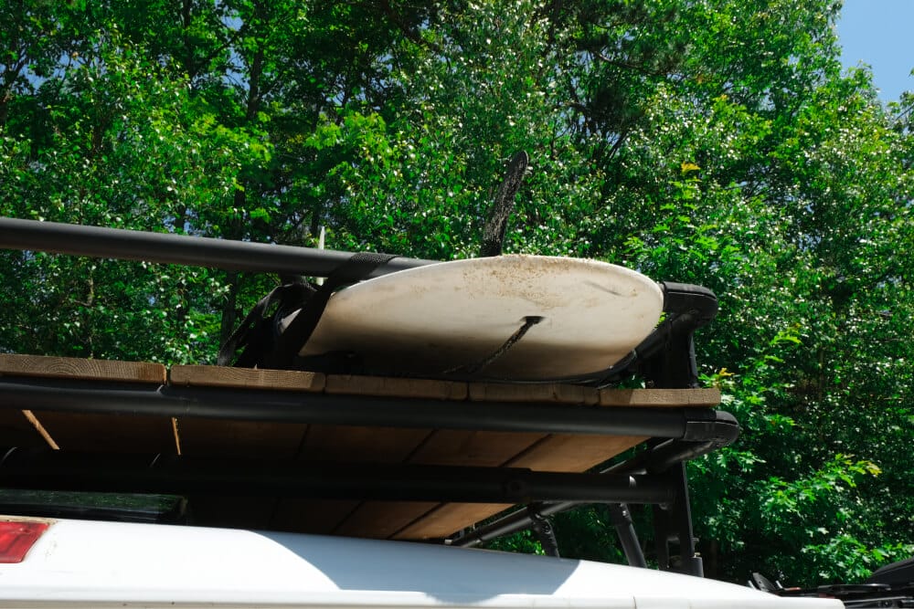 Van roof rack with surfboard storage